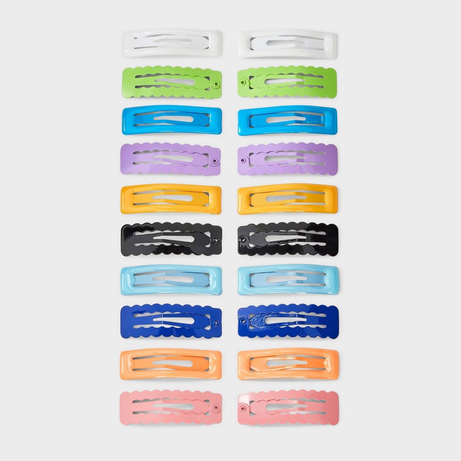 Flat lay of many small rectangular snap hair clips in assorted colors