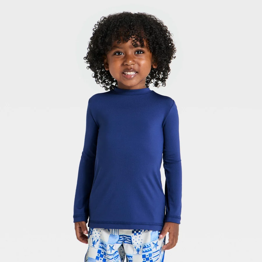 Navy long-sleeve rash guard style top for young children on a light background