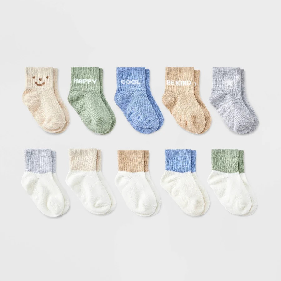 Assorted pastel low-cut baby socks arranged on a plain background