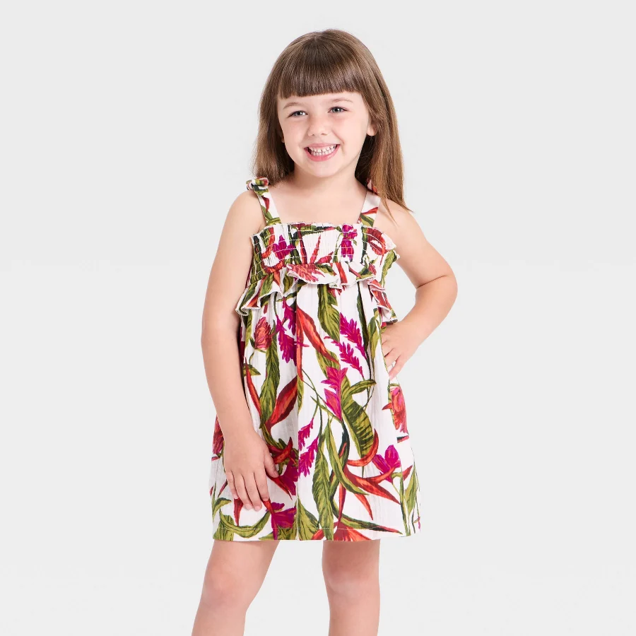 Toddler dress with smocked bodice and palm leaf print skirt