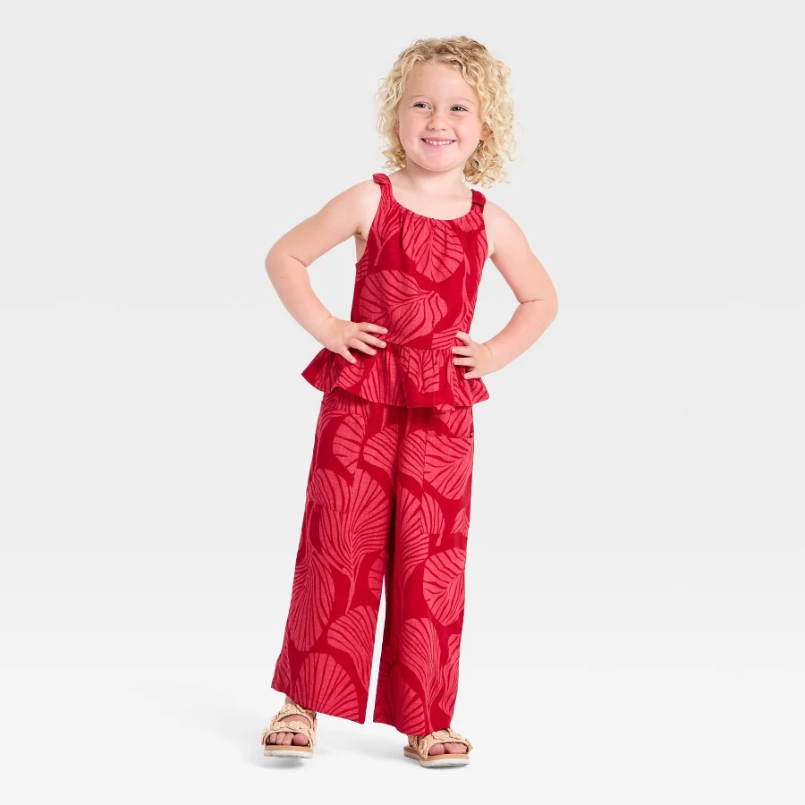 Coral two-piece toddler outfit with bow straps at the shoulders